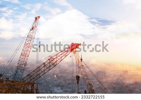 the tower crane and mobile crane and collar crane and construction site in the afternoon time with sunset. there are slings, and hooks, to try to build the city. Royalty-Free Stock Photo #2332722155