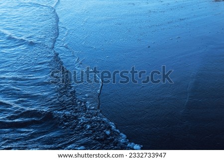 Photo illustration of a view of a choppy sea and beach and blue sky in a tropical country