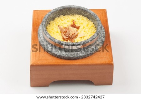 Rice cooked in a stone pot with healthy ginkgo, jujube, ginseng, and miscellaneous grains. Royalty-Free Stock Photo #2332742427