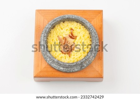 Rice cooked in a stone pot with healthy ginkgo, jujube, ginseng, and miscellaneous grains. Royalty-Free Stock Photo #2332742429