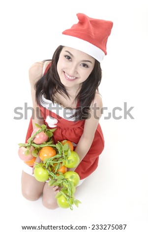 Pretty Santa Claus girl holding a red apple