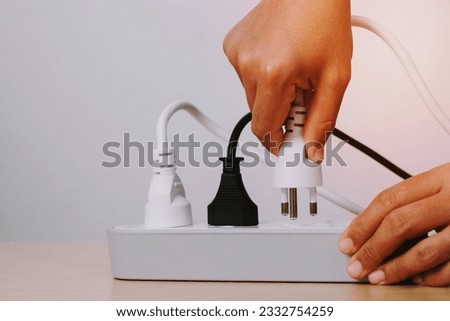 Electrical appliances plugs full of all plugs or plugs together. Because of the risk of causing a short circuit from high heat accumulated in the wires. Royalty-Free Stock Photo #2332754259