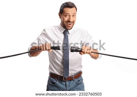Man unplugging cables and smiling isolated on white background Royalty-Free Stock Photo #2332760503