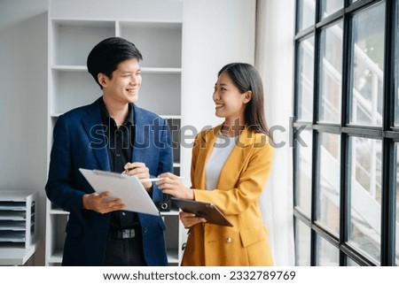 Asian business colleague business presents and explains and using laptop and tablet. Teamwork, financial marketing team,   while sitting in office room.
 Royalty-Free Stock Photo #2332789769