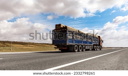 Large trucks drive on grassland roads in western China