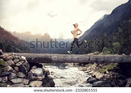 Woman trail runner cross country running in high altitude mountains  Royalty-Free Stock Photo #2332801555