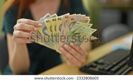 Young redhead woman business worker counting romanian leu banknotes at office Royalty-Free Stock Photo #2332808605