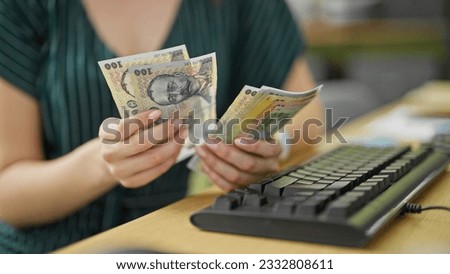 Young redhead woman business worker counting romanian leu banknotes at office Royalty-Free Stock Photo #2332808611
