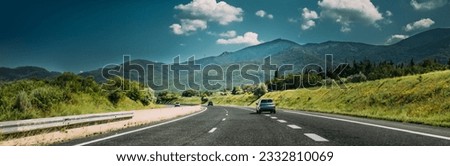Compact Crossover SUV In Motion On Road, Freeway, Motorway, Highway In Mountains Landscape. Drive And Travel Concept Royalty-Free Stock Photo #2332810069