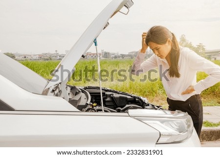 Troubled business woman commuting to work in the morning car suddenly stopped on the road parked on the sidewalk worried opened the hood the car looked at the engine damage confused needed help.