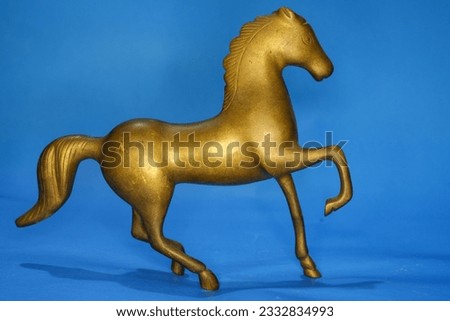 Vintage metallic showpiece or gift item portraying a running horse  Royalty-Free Stock Photo #2332834993