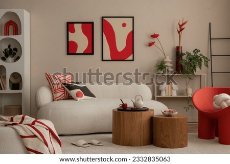 Interior design of modern and cozy living room interior with mock up poster frame, red armchair, wooden coffee table, pillows, vase with flowers and personal accessories. Home decor. Template.  Royalty-Free Stock Photo #2332835063