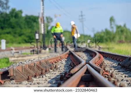 Selective focus on railway line Workers or engineers who maintain railway tracks Check the switchgear building process and check the work in the train station. Royalty-Free Stock Photo #2332840463