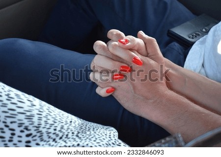 Woman's hand on a man's leg. Woman flirting with a man