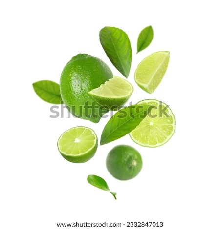 Fresh lime fruits and green leaves falling on white background Royalty-Free Stock Photo #2332847013