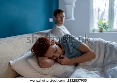 Sad offended woman after quarrel with boyfriend in bedroom. Difficult relations family conflict. Depressed female lies on edge of bed separated from man husband after argument of hard conversation. Royalty-Free Stock Photo #2332857955