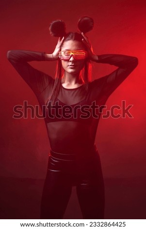 Portrait of beautiful cyber model woman posing wearing led glasses on head with neon light in a virtual tech environment