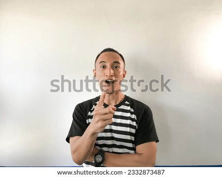 Portrait of Young Asian man thinking about an idea. Happy, strong, and amazed. Indonesia Man wear stripe shirt Isolated white background.