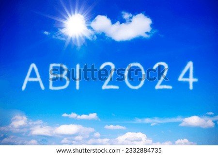 ABI 2024 written on sunny blue sky. Translation: German sign for succesfully completed high school graduation exams, concept of achievement and freedom.