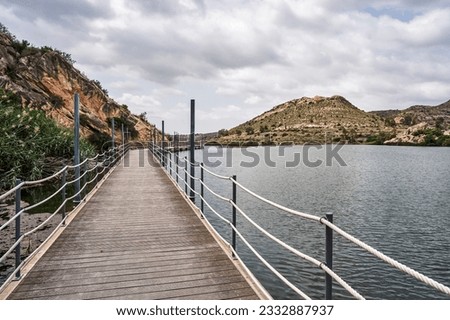 Footbridge in the Elche reservoir. In this footbridge you can see the nature of the environment. In Elche, Alicante, Valencian community, Spain