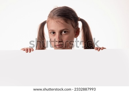 Young girl behind white blank banner or empty copy space advertisement board on brown background, Copy space.