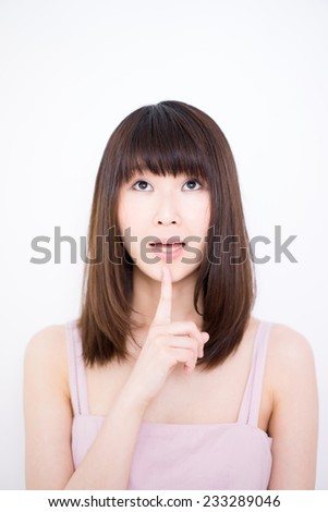 young woman thinking against white background