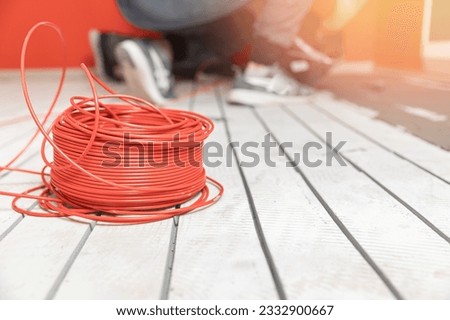 Process master install underfloor heating electrical cable. Royalty-Free Stock Photo #2332900667