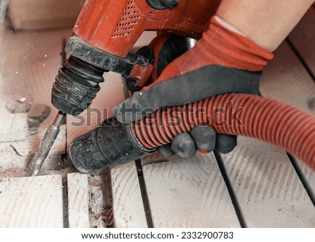 Construction worker use vacuum cleaning concrete floor for Install underfloor heating electrical cable. Royalty-Free Stock Photo #2332900783