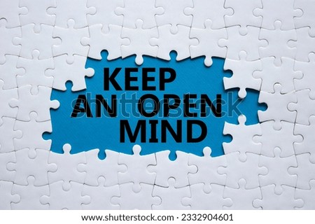 Keep an open mind symbol. White puzzle with words Keep an open mind. Beautiful blue background. Business and Keep an open mind concept. Copy space.