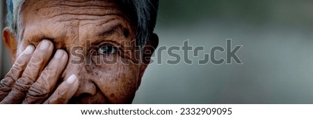 Old women cover her eye with her hand for eye testing use for medical and healthcare background Royalty-Free Stock Photo #2332909095
