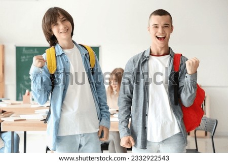 Happy male students in classroom Royalty-Free Stock Photo #2332922543