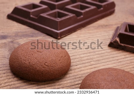 Close-up chocolate cookies with pieces of dark chocolate on rustic wooden table Royalty-Free Stock Photo #2332936471