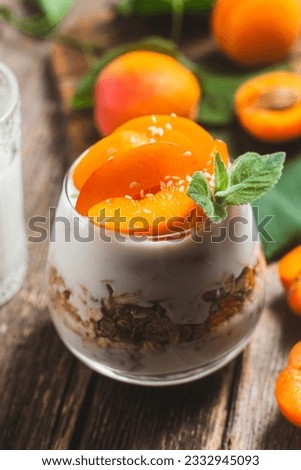 Granola with yogurt and apricots in a glass