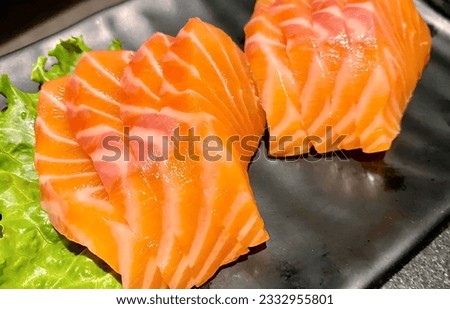 a photography of two pieces of sushi on a plate, there are two pieces of sushi on a plate with lettuce.