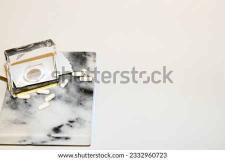 pharmacy vial with pills, pills on a marble stand, pharmacy, medical capsules, vitamins on marble, pharmacy shelf, medicines on gray marble, background for a prescription, drugs in an old vial, ampoul