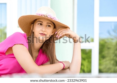 Beautiful girl looking around, a house with big windows in the background