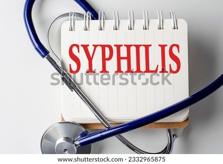 SYPHILIS word on a notebook with medical equipment on background