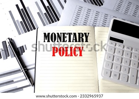 MONETARY POLICY text written on notebook on chart and diagram Royalty-Free Stock Photo #2332965937