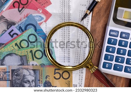Different Australian banknotes bills under magnifying glass. Aussie currency. Finance concept Royalty-Free Stock Photo #2332980323