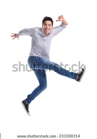 young casual man jumping for joy Royalty-Free Stock Photo #233300314