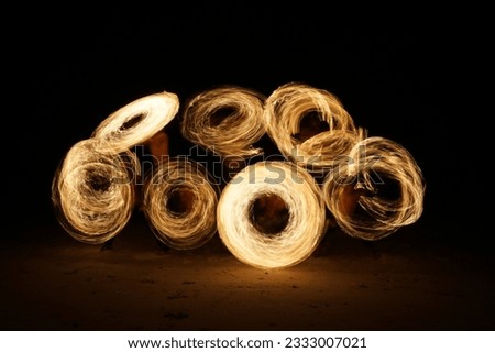 A fire show at Koh Kood island, Thailand. This picture was taken with slow shutter speed which created an picture of drawing fire