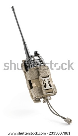 Military radio in tactical pouch in pixel camouflage. Military gear, equipment. Walkie talkie.