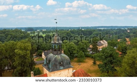 Lielstraupe Medieval Castle in the Village of Straupe in Vidzeme, in Northern Latvia. Aerial Dron Shot Lielstraupe Castle United in One Corps With the Church Surrounded by a Park With Pond.