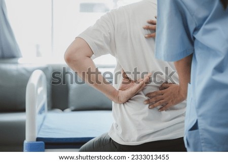 Physiotherapist doing physiotherapy for patient in a hospital room, physiotherapy helps to recover from illness by moving the body and muscles. The concept of treating illnesses with physical therapy. Royalty-Free Stock Photo #2333013455