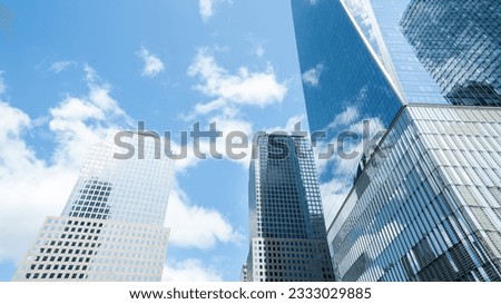 New York City, NY, USA - June 7 2023 : Close view of the skyscrapers of New York City from the streets The clouds create a beautiful reflexion on the buildings' windows. Royalty-Free Stock Photo #2333029885