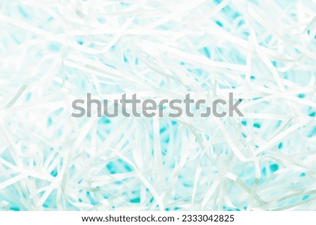 shredded paper on pastel blue background 