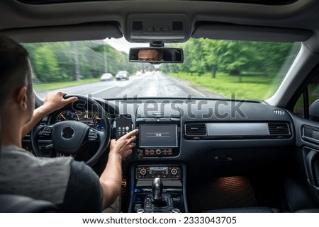 Hands on the wheel when driving from inside the car. Royalty-Free Stock Photo #2333043705