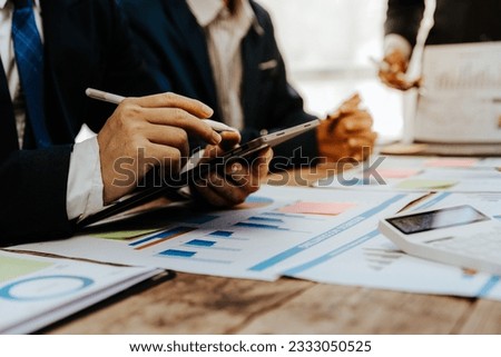 Team of business people meeting for business planning, brainstorming, accounting, tax and brokerage. Royalty-Free Stock Photo #2333050525
