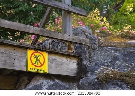 No climbing warning sign of danger in public park. Do no climb on rocks sign. Travel photo, nobody