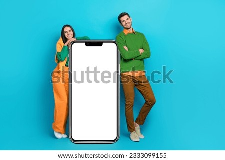 Photo of two people bloggers advertise electronics gadget mobile phone board isolated on blue color background